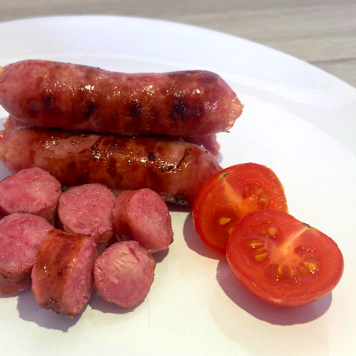 A plate of sausages and tomatoes

AI-generated content may be incorrect.