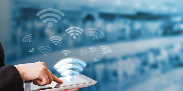 Illustration of a hand holding a tablet, with a visible WiFi symbol on the screen, representing wireless connectivity and modern digital interaction