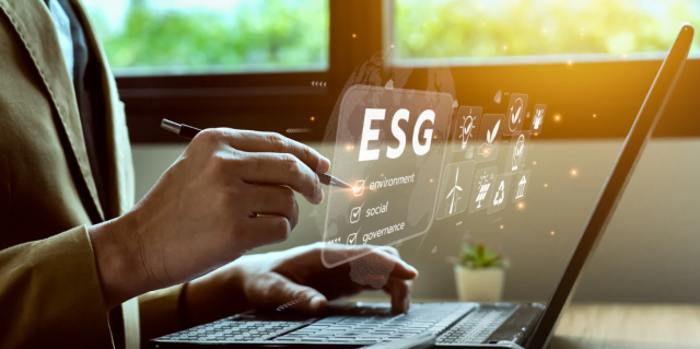 Man using a computer with 'ESG' highlighted at the center, representing the use of technology in managing environmental, social, and governance practice